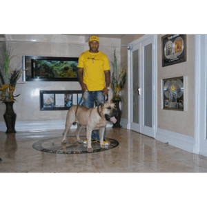 Flo Rida standing with a beige Presa Canario