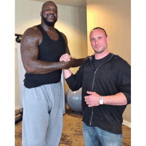 Sanders Kennel employee shaking hands with Shaquille O'Neal