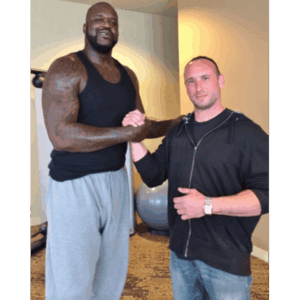 Sanders Kennel employee shaking hands with Shaquille O'Neal